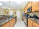 Functional kitchen featuring stainless steel appliances, granite countertops, and a convenient layout for cooking and meal prep at 5012 Shoreway Loop # 10207, Orlando, FL 32819