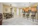 Open kitchen with stainless steel appliances, granite countertops, a breakfast bar, and a dining area nearby at 5012 Shoreway Loop # 10207, Orlando, FL 32819