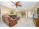 Cozy living area with leather seating, ceiling fan, and an open layout flowing into the kitchen and dining spaces at 5012 Shoreway Loop # 10207, Orlando, FL 32819