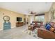 Comfortable living room showcasing a leather sofa, ceiling fan, and neutral tones for a relaxing atmosphere at 5012 Shoreway Loop # 10207, Orlando, FL 32819