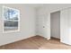 Bright bedroom with wood-look flooring, closet, and window view at 579 Marion Oaks Ln, Ocala, FL 34473