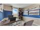 Home office with wood desk, two chairs and blue and beige wall decor at 6618 Leo Ln, St Cloud, FL 34773