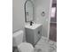 Clean bathroom, gray vanity, marble-look floor, arched mirror at 701 Titcomb St, Eustis, FL 32726