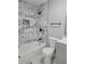 Renovated bathroom with marble-look tile and bathtub at 701 Titcomb St, Eustis, FL 32726