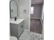 Bathroom with gray vanity, marble flooring, and view of bedroom at 701 Titcomb St, Eustis, FL 32726