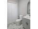 Updated bathroom with gray vanity, marble flooring, and a modern toilet at 701 Titcomb St, Eustis, FL 32726