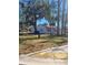 Front view of newly painted house with mature trees and curb appeal at 701 Titcomb St, Eustis, FL 32726