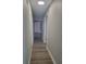 Bright hallway with wood-look flooring and access to other rooms at 701 Titcomb St, Eustis, FL 32726