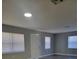 Bright living room with gray walls, vinyl flooring, and window blinds at 701 Titcomb St, Eustis, FL 32726