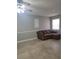 Living room with tile floor and brown sectional sofa at 701 Titcomb St, Eustis, FL 32726