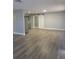 Spacious living area featuring gray vinyl flooring and a barn door at 701 Titcomb St, Eustis, FL 32726