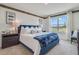 Spacious bedroom with king-size bed and blue velvet headboard at 7092 Painted Bunting Way, St Cloud, FL 34773