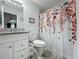 Clean bathroom with granite countertop and floral shower curtain at 7211 Pinion Dr, Orlando, FL 32818