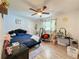 Cozy bedroom with a double bed, ceiling fan, and wood-look floors at 7211 Pinion Dr, Orlando, FL 32818