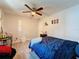 Bedroom with double bed, ceiling fan, and wood-look floors at 7211 Pinion Dr, Orlando, FL 32818