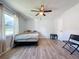 Bedroom with double bed, ceiling fan, and wood-look floors at 7211 Pinion Dr, Orlando, FL 32818