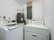 Laundry room with washer, dryer, and hot water heater at 7211 Pinion Dr, Orlando, FL 32818