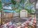 Landscaped backyard with storage shed and patio at 767 Trailwood Dr, Altamonte Springs, FL 32714