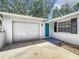 Bright teal front door and attached garage at 767 Trailwood Dr, Altamonte Springs, FL 32714