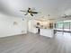 Bright and open living room with grey vinyl flooring and kitchen view at 767 Trailwood Dr, Altamonte Springs, FL 32714