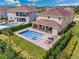 Aerial view of a house with a pool and landscaped backyard at 7723 Graben St, Kissimmee, FL 34747