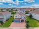 Aerial view of a two story house with a paver driveway at 7723 Graben St, Kissimmee, FL 34747