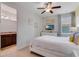 Bedroom with a queen-size bed, TV, and adjacent bathroom at 7723 Graben St, Kissimmee, FL 34747