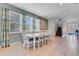 Spacious dining area with white table and chairs near kitchen at 7723 Graben St, Kissimmee, FL 34747