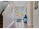 Bright and airy entryway with tiled floors and staircase at 7723 Graben St, Kissimmee, FL 34747