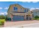 Two-story house with gray garage doors and stone accents at 7723 Graben St, Kissimmee, FL 34747