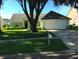 House exterior featuring a two-car garage and lawn at 7808 Rollingridge Ct, Orlando, FL 32835