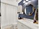 Modern bathroom with a white vanity and navy blue walls at 833 Ellwood Ave, Orlando, FL 32804