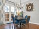 Charming dining room with blue chairs and hardwood floors at 833 Ellwood Ave, Orlando, FL 32804