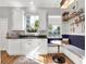 Kitchen with white cabinets, a built-in bench, and a window at 833 Ellwood Ave, Orlando, FL 32804