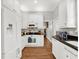 White kitchen with black countertops and stainless steel appliances at 833 Ellwood Ave, Orlando, FL 32804