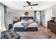 Main bedroom with king-size bed, hardwood floors, and access to a balcony at 833 Ellwood Ave, Orlando, FL 32804