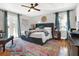 Main bedroom with king-size bed, hardwood floors, and access to a balcony at 833 Ellwood Ave, Orlando, FL 32804