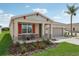 One-story house with red accents, stone facade, and a two-car garage at 879 Pebble Crest Ln, Eagle Lake, FL 33839