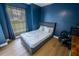 Bedroom with dark blue walls and a gray bed at 883 Montrose Ave, Orange City, FL 32763