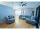 Light and bright living room with gray sectional and accent chairs at 883 Montrose Ave, Orange City, FL 32763