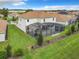 Aerial view of the home showcasing the expansive yard and screened-in patio perfect for outdoor living and entertaining at 8886 Fallen Oak Dr, Davenport, FL 33896