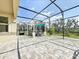 Large screened patio with hot tub and view of the backyard at 8886 Fallen Oak Dr, Davenport, FL 33896