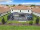 Home's backyard featuring an enclosed pool area, patio, and well-maintained landscaping at 8886 Fallen Oak Dr, Davenport, FL 33896