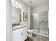 Bright bathroom featuring modern vanity and walk-in shower with glass door at 8886 Fallen Oak Dr, Davenport, FL 33896