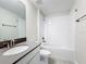 This bathroom features a bathtub, a vanity with a white sink, and modern fixtures at 8886 Fallen Oak Dr, Davenport, FL 33896