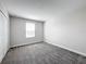 Bedroom with a window and neutral colored carpet at 8886 Fallen Oak Dr, Davenport, FL 33896