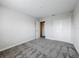 This bedroom boasts neutral walls, carpet flooring, a closet, and an adjacent door to another room at 8886 Fallen Oak Dr, Davenport, FL 33896