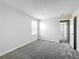 This bedroom showcases a neutral color scheme, carpet flooring, and a window offering natural light at 8886 Fallen Oak Dr, Davenport, FL 33896