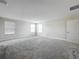 Bright bedroom with neutral walls, carpet floors, multiple windows, and a large door at 8886 Fallen Oak Dr, Davenport, FL 33896