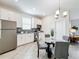 Bright dining area featuring stainless steel appliances, modern cabinets and a stylish glass table at 8886 Fallen Oak Dr, Davenport, FL 33896